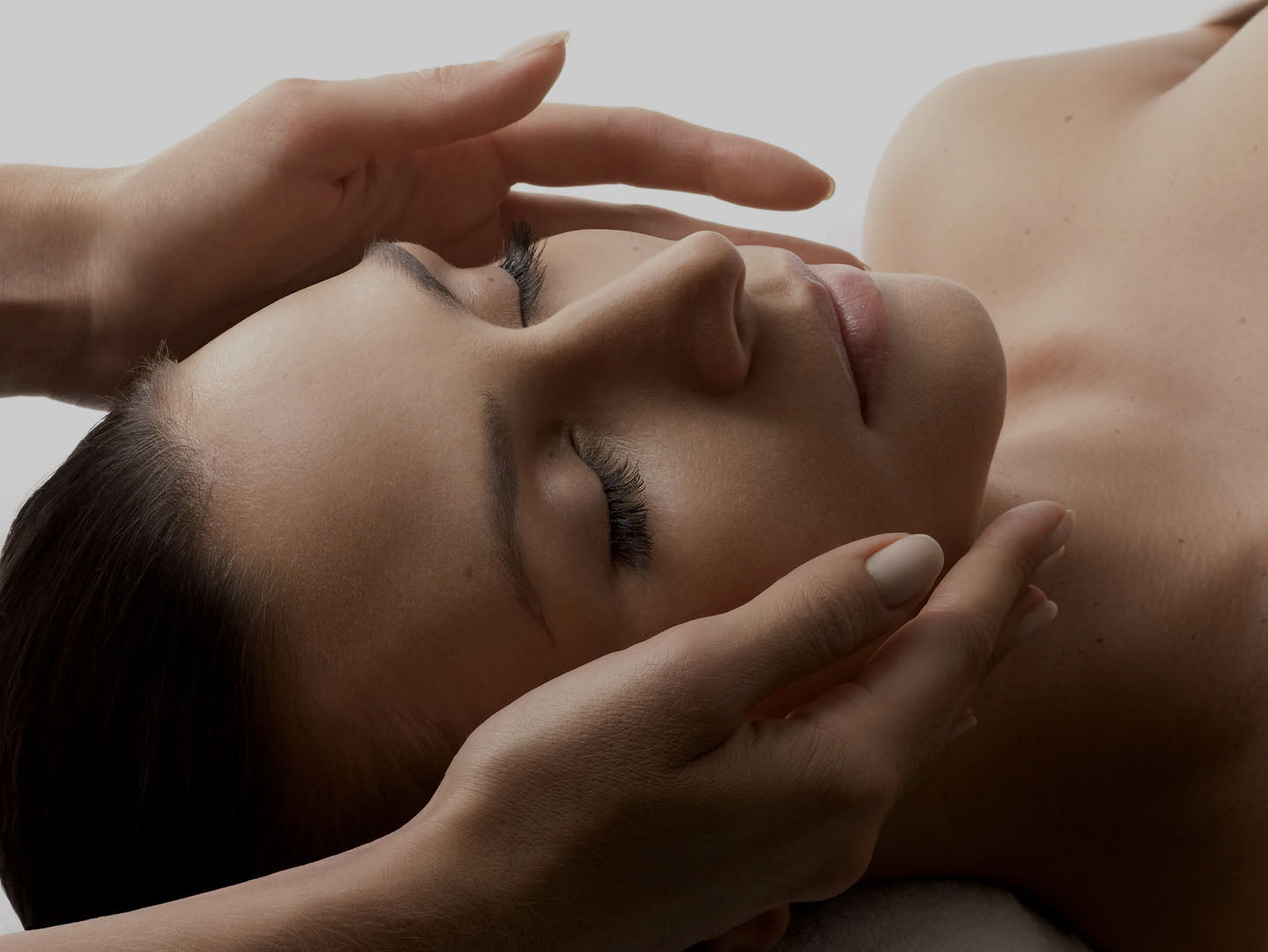 Close-up of a woman receiving a relaxing Orlane facial treatment for radiant, hydrated skin