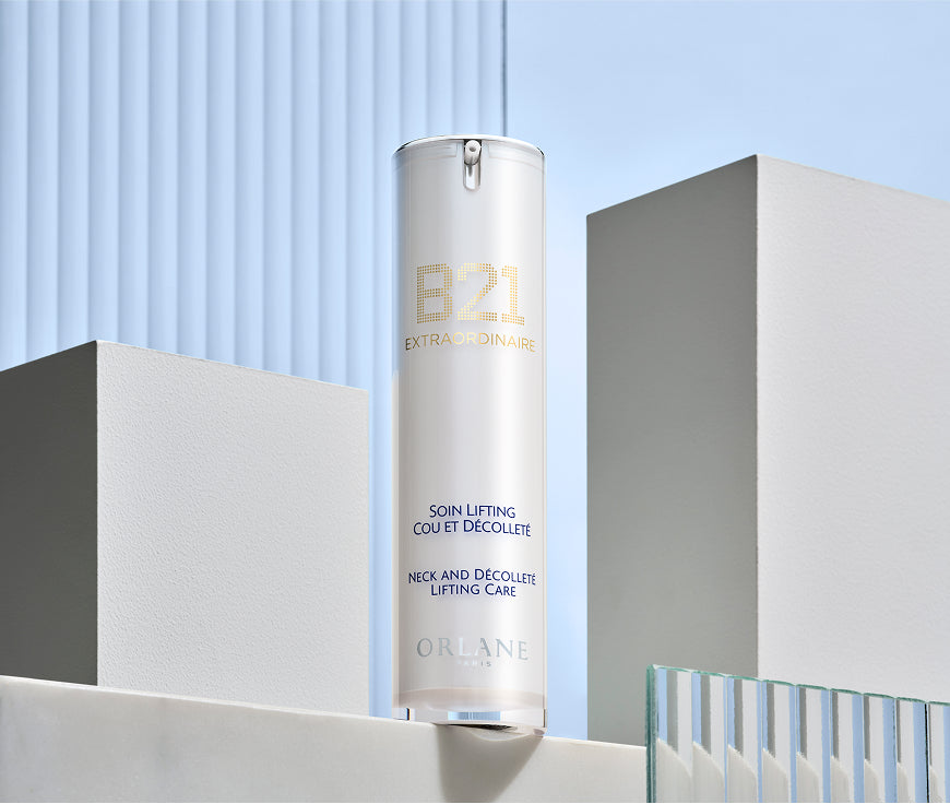 Orlane B21 Extraordinaire Neck and Décolleté Lifting Care bottle displayed against a modern architectural backdrop with soft blue tones